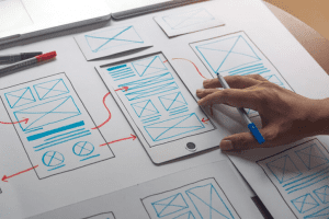 Person designing a website by hand