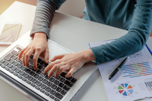 Woman typing on computer about high quality content