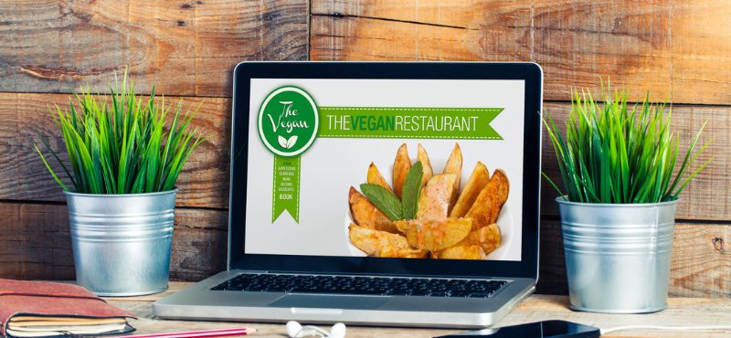 laptop with vegan restaurant menu on screen