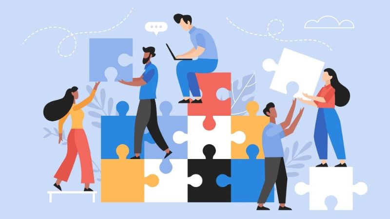 vector image of people sitting on puzzle pieces while working on social media