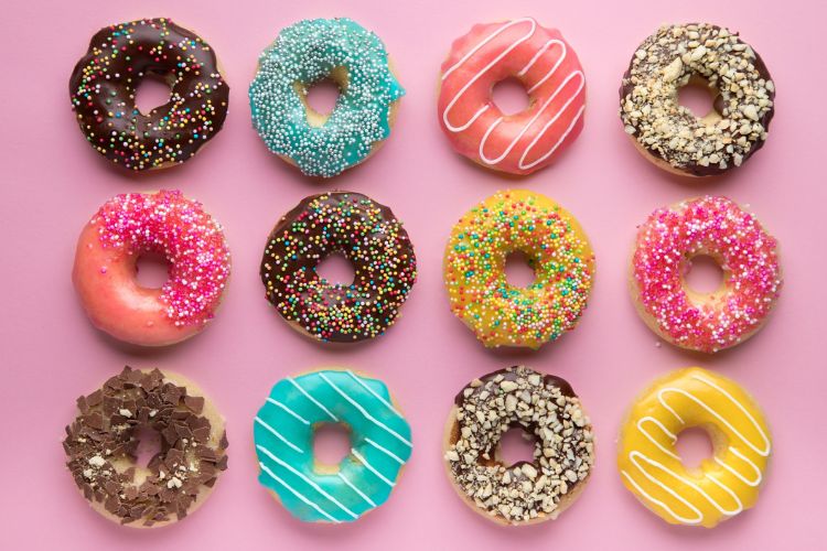 multi colored donuts laid out in a grid